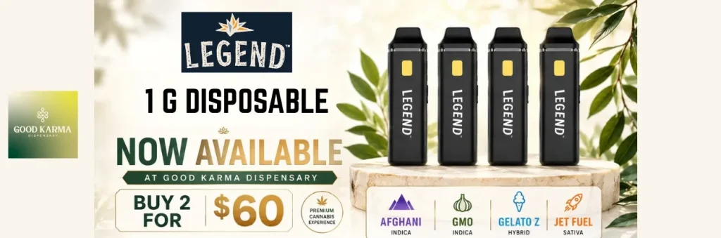 Two black vape devices on a wooden block with green leaves and text